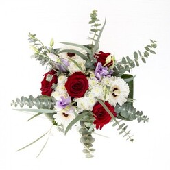 In Alperton, where tradition intertwines with a lively urban pulse, this bouquet is crafted to reflect both character and care. Imagine placing it on a sunlit kitchen table overlooking the Grand Union Canal-the vivid red roses at its centre declare affection and joy, their graceful petals spiraling outward in regal confidence. White gerberas, haloed by espresso-hued centres, serve as luminous anchors, their texture reminiscent of the celebrations in Alperton's colorful community halls. Scattered throughout are light pastel lisianthus, some still wrapped in budding secrecy, while others reveal their delicate forms-each one a gentle nod to new friendships or hopeful beginnings. Ethereal white filler blooms add airy softness, catching the light and creating a sense of movement. Abundant sprigs of eucalyptus fan out, imparting an unmistakable fresh, aromatic note and silvery hue that echo the leafy paths of nearby parks and the gentle breezes along Ealing Road. Framing leaves at the base are broad and glossy, bestowing both sturdiness and refined elegance. Through the glass vase, crisp green stems are visible, accentuating the bouquet's vitality and freshness. Whether sent as an anniversary token or a comforting gesture, this arrangement from Flowers Alperton captures the spirit of local artistry and heartfelt intention that define Alperton's neighbourhood charm.